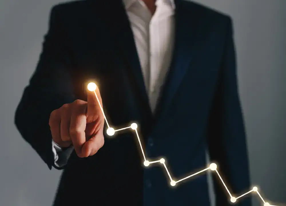 Quality assurance or procurement manager pointing to trend graphs or performance results