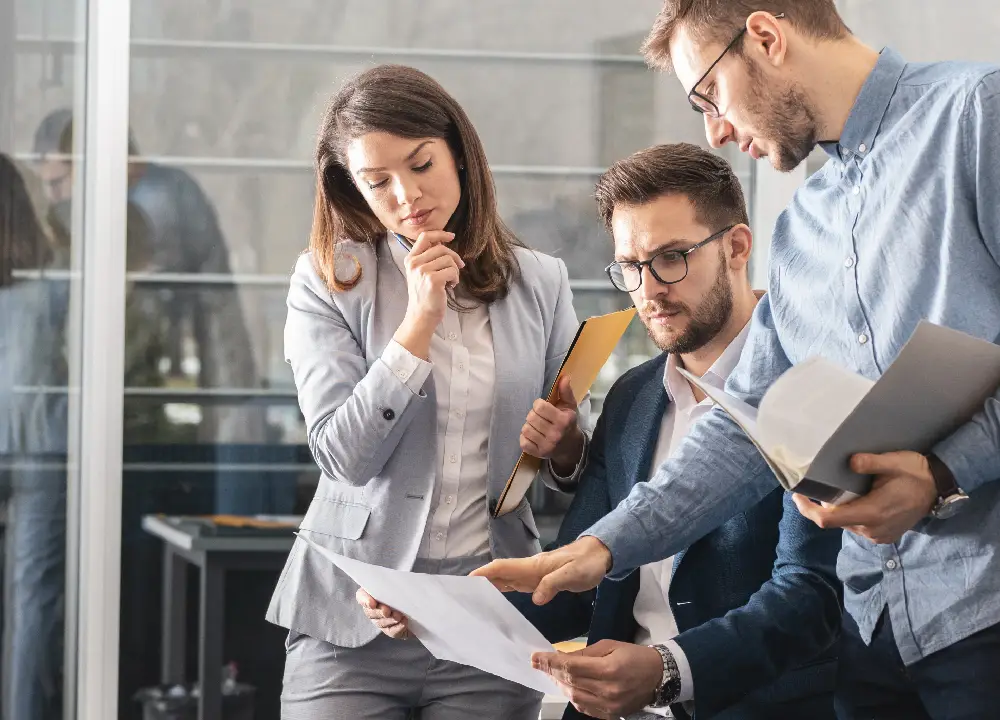 Team reviewing an integrated ISO 9001 and C‑TPAT compliance dashboard