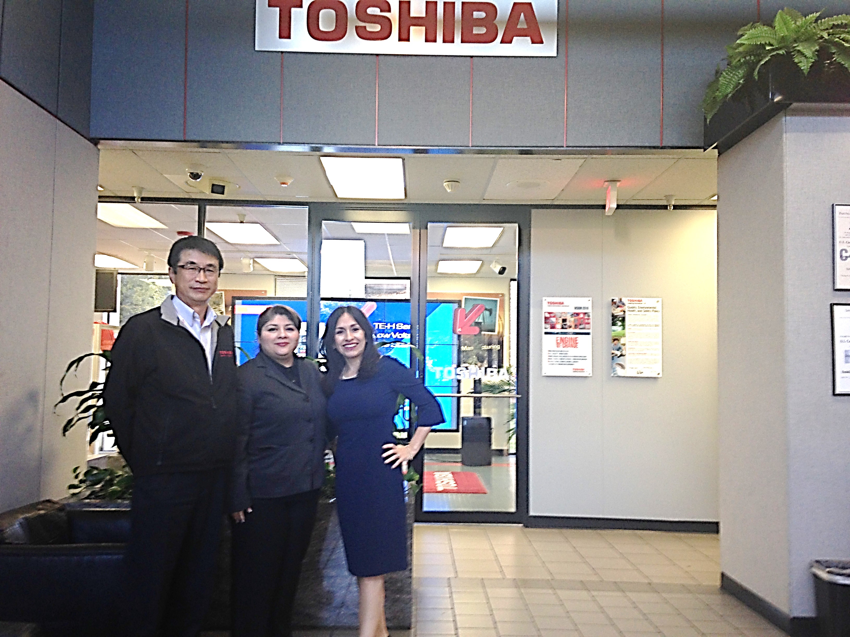 Miriam poses with Toshiba employees.