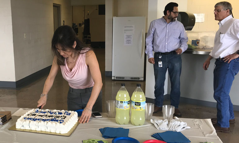 Miriam cuts the ISO 9001 celebration cake!